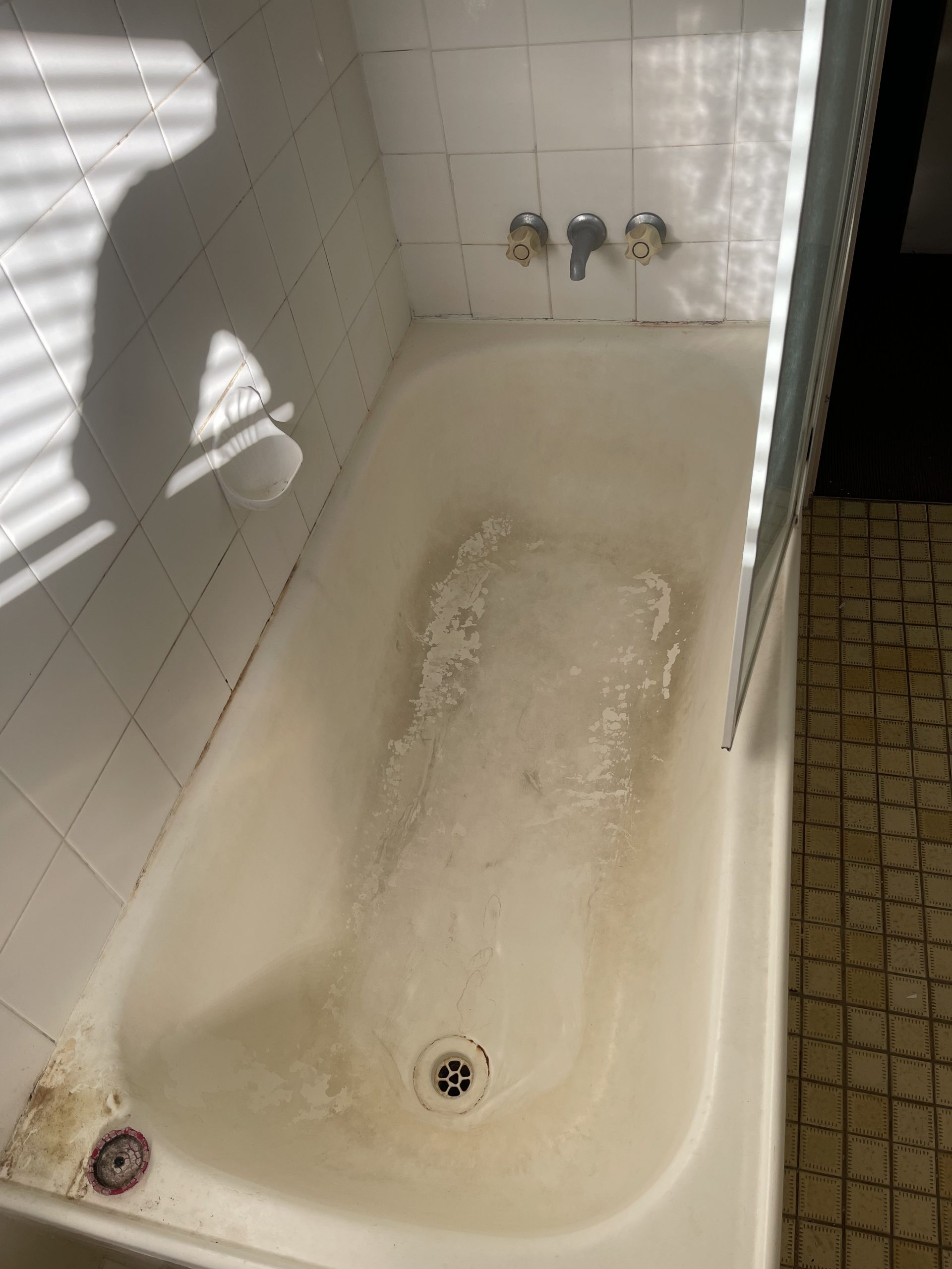 Bathtub with visible dirt and grime buildup, in need of a thorough cleaning.