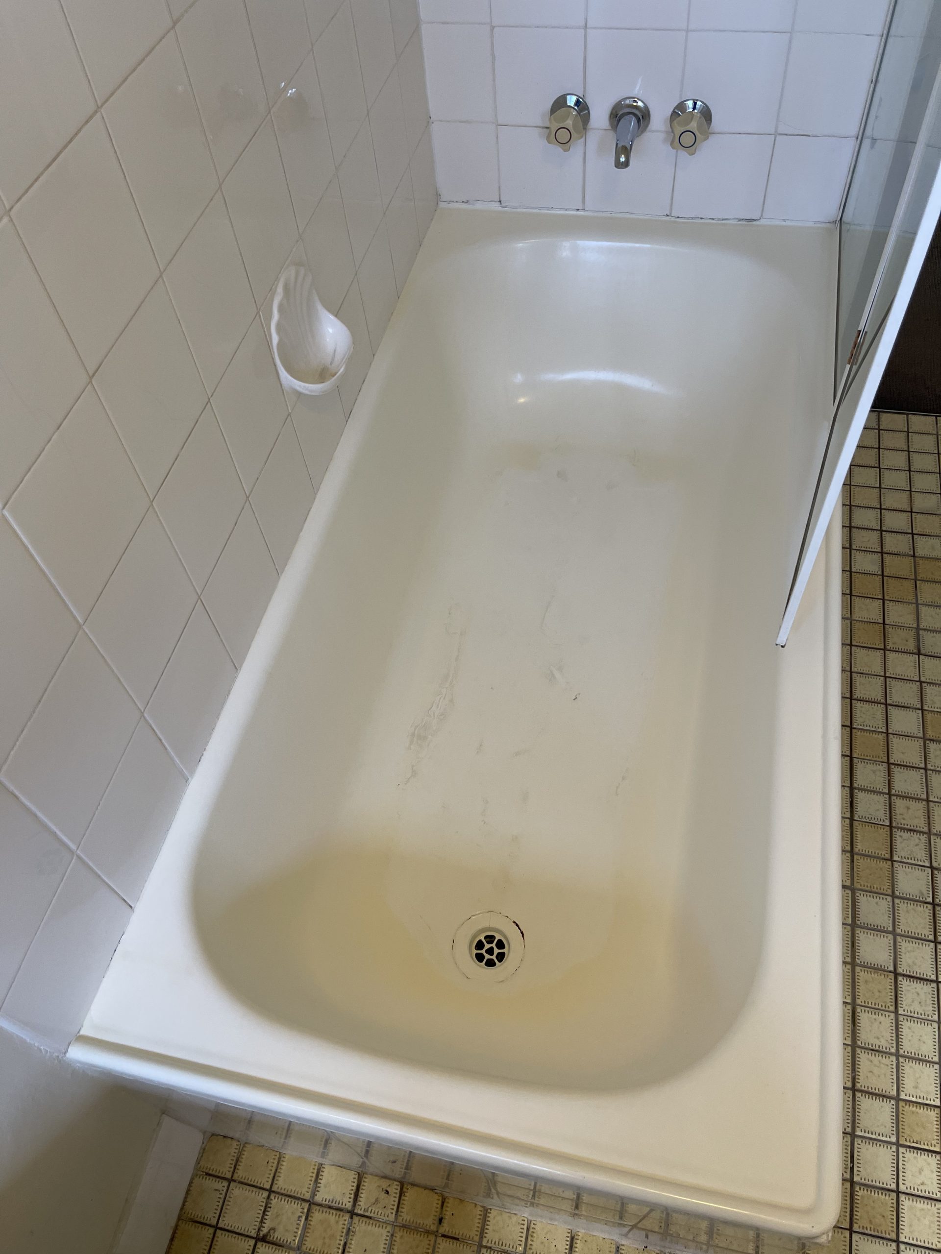 Bathtub sparkling clean and restored after professional deep cleaning service.