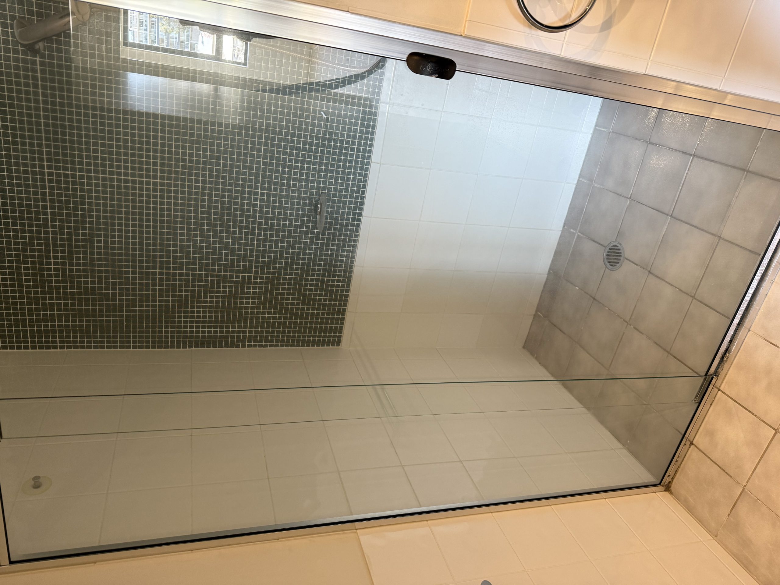 Clean glass shower door after soap scum removal